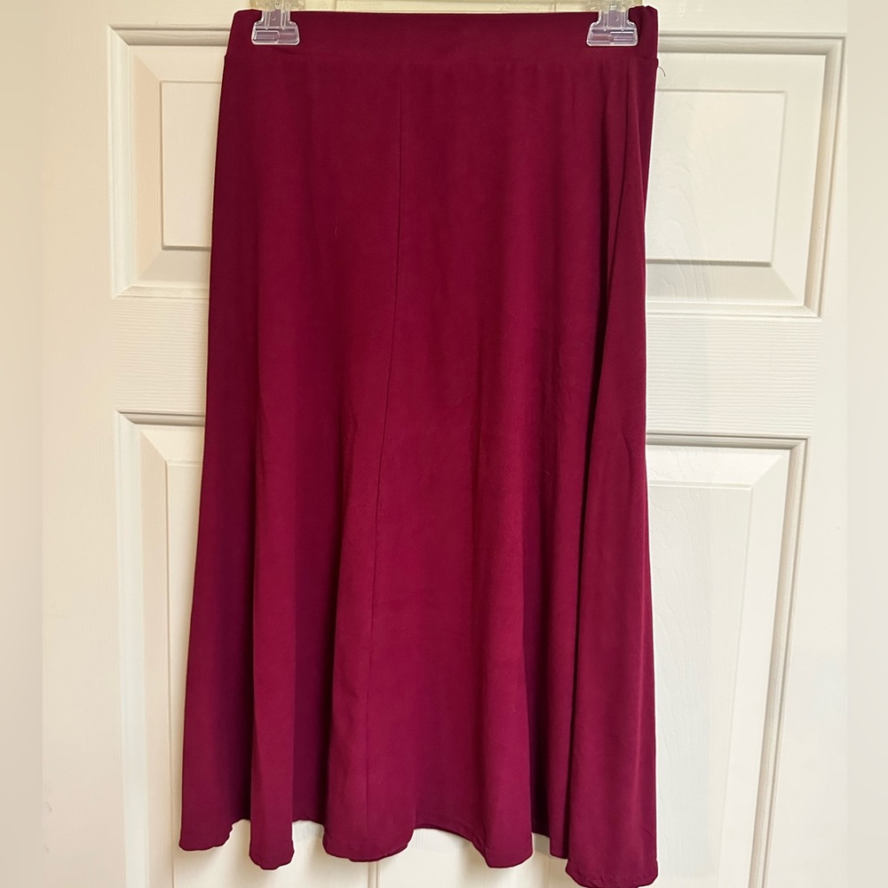 Fun, maroon skirt that hugs the hips but flows right below the knees.
